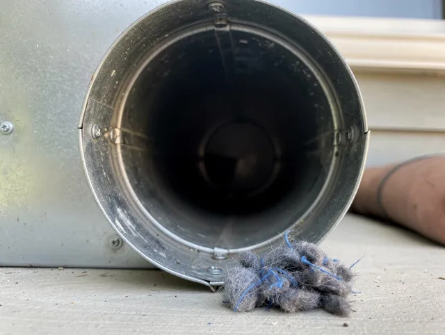 Port Chester Dryer Vent Cleaning technician using specialized equipment to clear severe dryer vent blockage in Port Chester